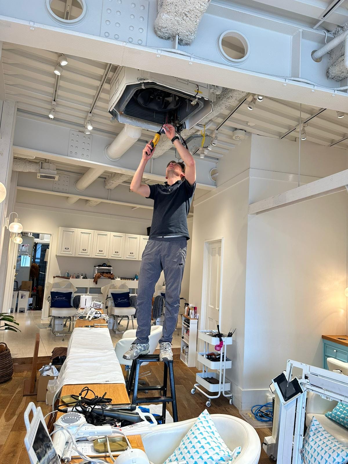 Technician cleaning air conditioner unit in Tokyo